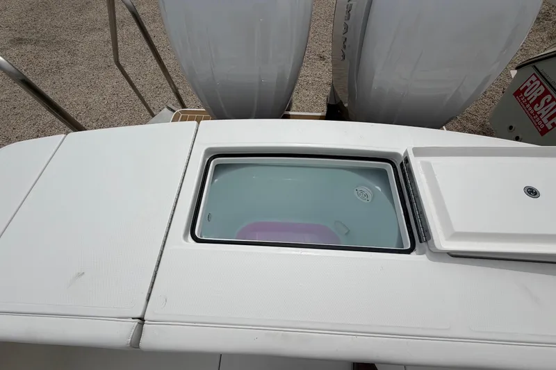 Slide: The Image of 2026 Regulator 28 boat with open storage compartment and "For Sale" sign visible. - 28