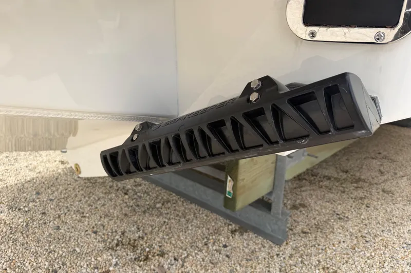 Slide: The Image of 2026 Regulator 28 boat detail with black step on gravel surface. - 31