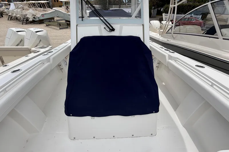 Slide: The Image of 2026 Regulator 28 boat interior with covered seating and visible Mercury engines. - 32