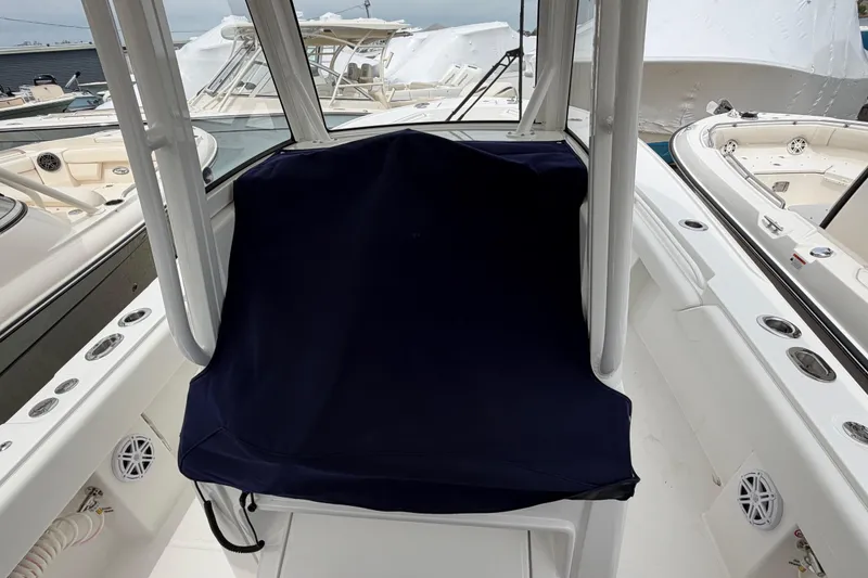 Slide: The Image of 2026 Regulator 28 boat interior with covered seating and sleek design. - 33