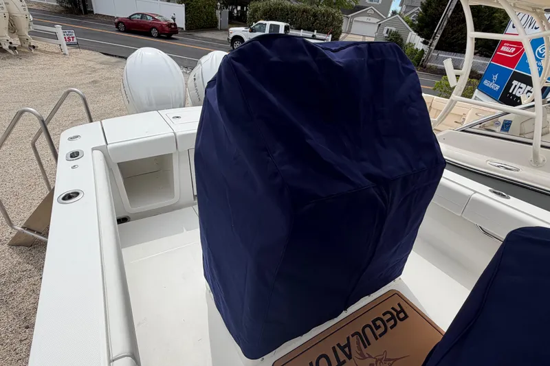 Slide: The Image of 2026 Regulator 28 boat interior with covered console and twin outboard motors. - 34