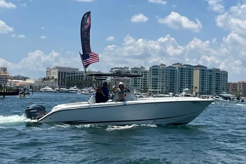 The Image of 1999 Hydra-Sports 3000 CC boat cruising on water with cityscape background. - 0