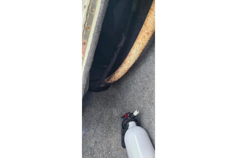 Slide: The Image of Interior of a 1999 Hydra-Sports 3000 CC boat with a fire extinguisher. - 11