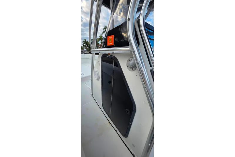 Slide: The Image of 1999 Hydra-Sports 3000 CC boat console with stainless steel railings and storage compartment. - 19