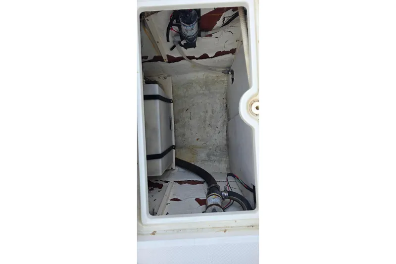 Slide: The Image of Interior compartment of a 1999 Hydra-Sports 3000 CC boat, showing wiring and hoses. - 23