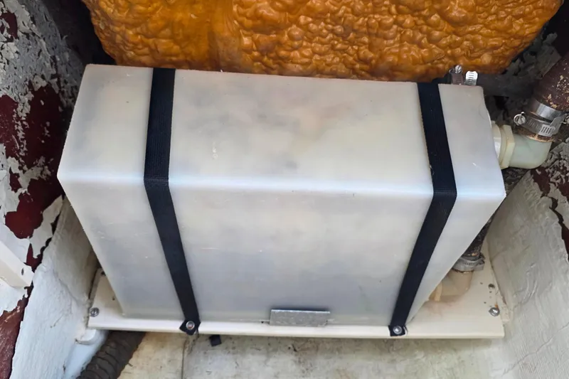 Slide: The Image of Plastic tank secured with straps inside a 1999 Hydra-Sports 3000 CC boat. - 24