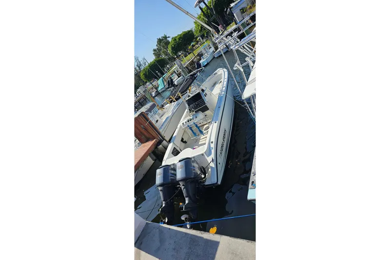 Slide: The Image of 1999 Hydra-Sports 3000 CC boat docked with dual Yamaha engines. - 4