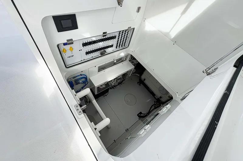 Slide: The Image of Manufacturer Provided Image: Engine compartment of 2026 HCB 48 Campeon boat, showcasing control panel and wiring. - 13