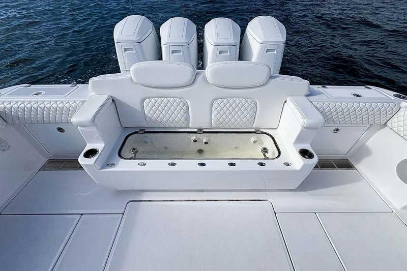 Slide: The Image of Manufacturer Provided Image: Luxury seating and storage on 2026 HCB 48 Campeon boat, with quilted upholstery and cup holders. - 19