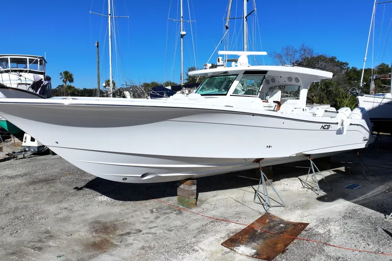 Slide: The Image of 2026 HCB 48 Campeon boat on dry dock, surrounded by other vessels. - 2