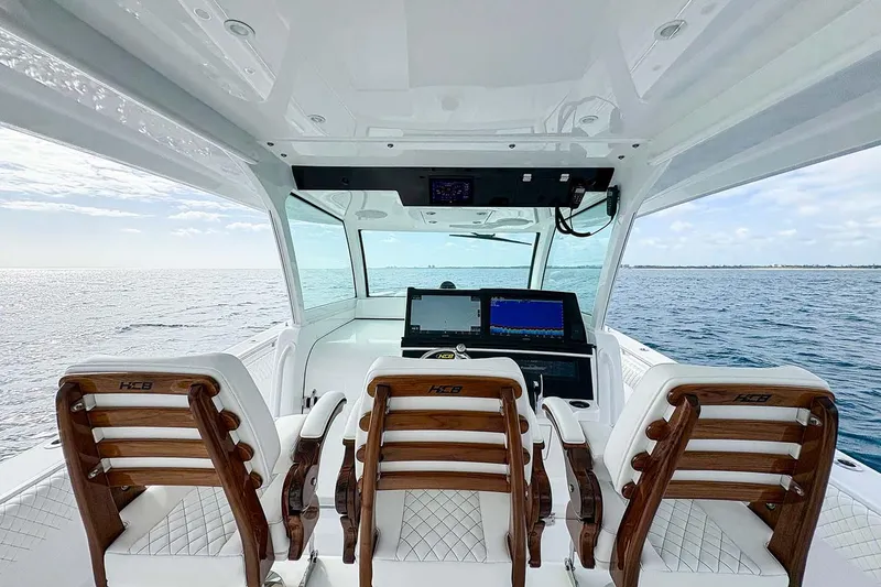 Slide: The Image of Manufacturer Provided Image: Interior view of 2026 HCB 48 Campeon boat with luxurious seating and ocean backdrop. - 21