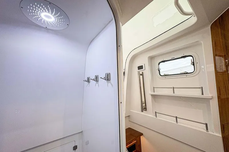 Slide: The Image of Manufacturer Provided Image: Interior of 2026 HCB 48 Campeon boat featuring modern shower and window. - 30