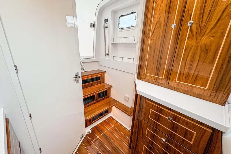 Slide: The Image of Manufacturer Provided Image: Luxurious interior of 2026 HCB 48 Campeon yacht with wooden cabinetry and stairs. - 31