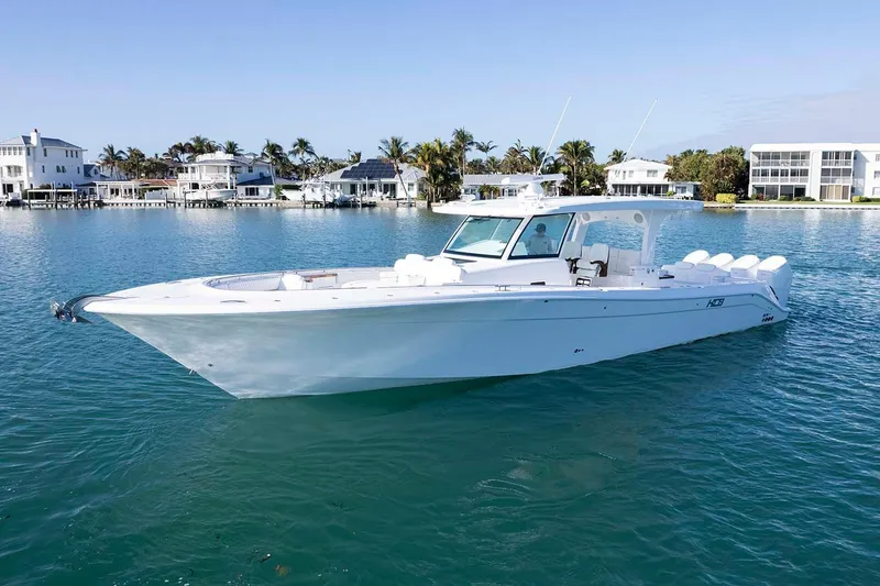 Slide: The Image of Manufacturer Provided Image: 2026 HCB 48 Campeon boat on clear water near luxury waterfront homes. - 5