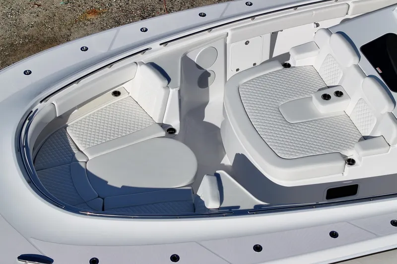 Slide: The Image of Luxurious seating area on 2026 HCB 48 Campeon boat, featuring quilted white upholstery. - 8