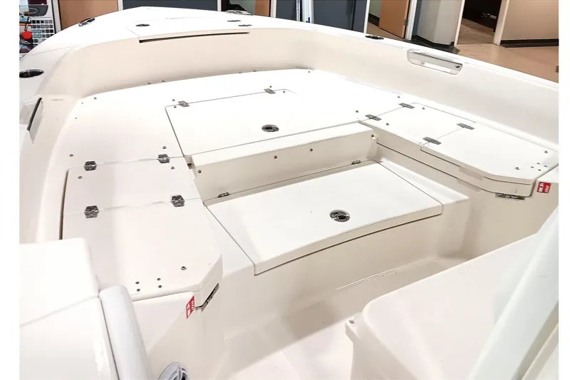 Slide: The Image of 2026 Pathfinder 2400 TRS boat interior with storage compartments and seating area. - 11