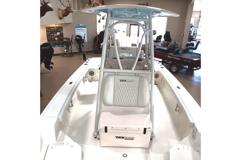Slide: The Image of 2026 Pathfinder 2400 TRS boat interior with seating and console, displayed indoors. - 13