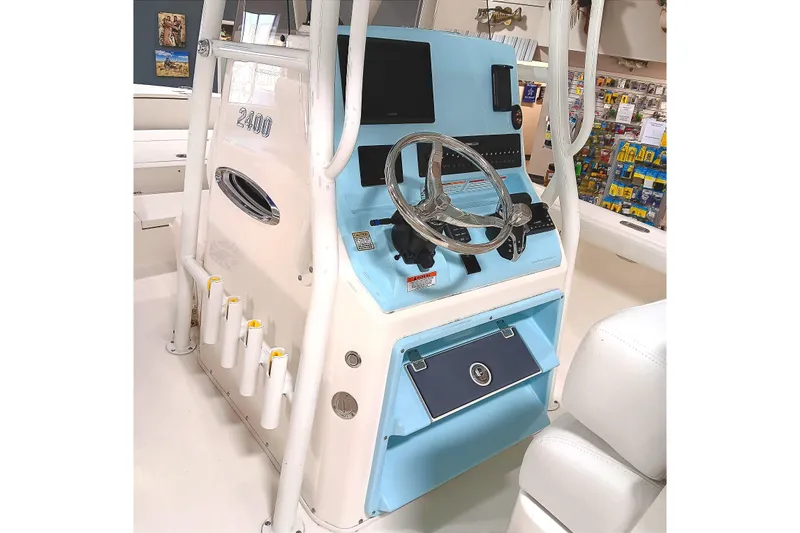 Slide: The Image of 2026 Pathfinder 2400 TRS boat console with steering wheel and controls. - 15