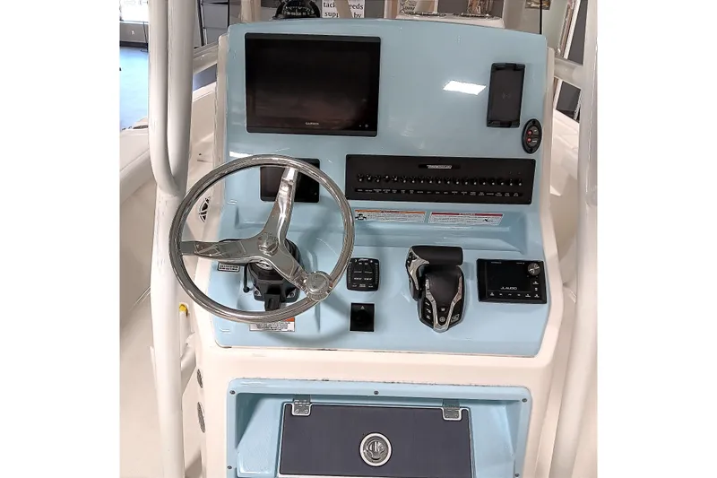 Slide: The Image of 2026 Pathfinder 2400 TRS boat console with steering wheel, controls, and display screen. - 16