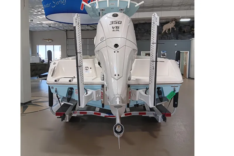 Slide: The Image of 2026 Pathfinder 2400 TRS boat with V6 engine displayed indoors. - 6