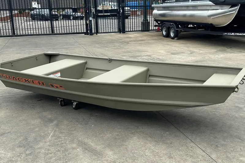 The Image of 2026 Tracker Grizzly 12 Jon boat on concrete surface, showcasing its sturdy design. - 0