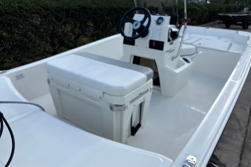 Slide: The Image of 2026 Mako Pro Skiff 15 CC boat interior with steering console and seating. - 9