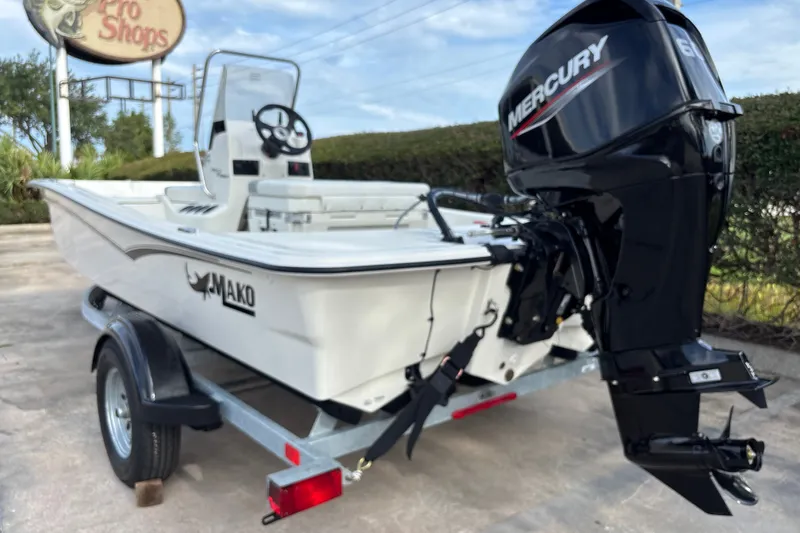 Slide: The Image of 2026 Mako Pro Skiff 15 CC boat with Mercury engine on trailer. - 2