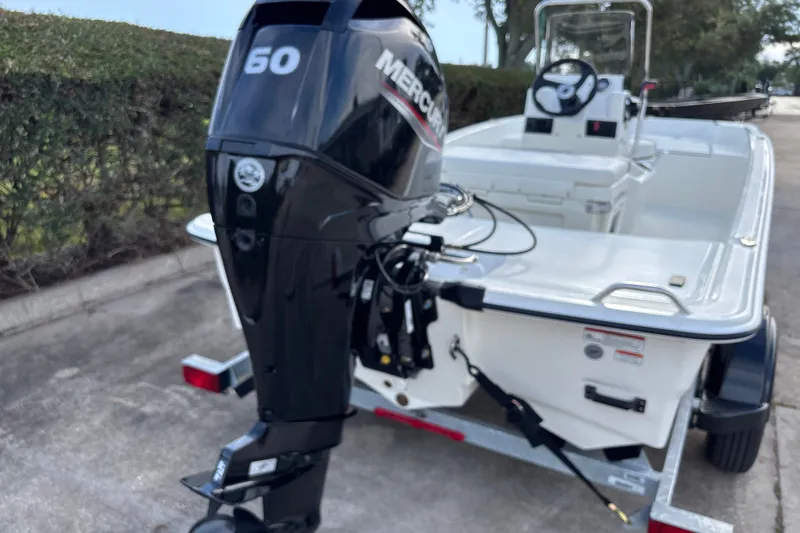 Slide: The Image of 2026 Mako Pro Skiff 15 CC with Mercury 50 HP outboard engine on trailer. - 6