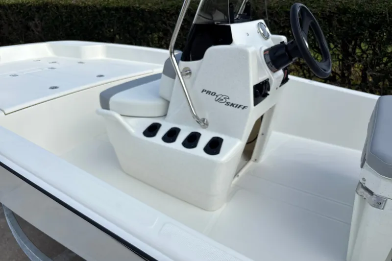 Slide: The Image of 2026 Mako Pro Skiff 15 CC boat interior with steering console and seating. - 11