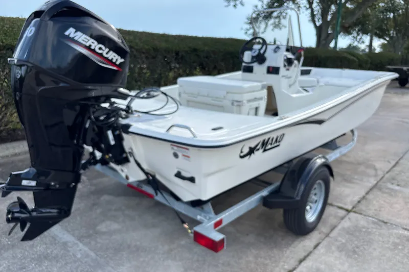 Slide: The Image of 2026 Mako Pro Skiff 15 CC boat with Mercury outboard motor on trailer. - 5