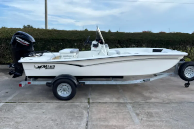 Slide: The Image of 2026 Mako Pro Skiff 15 CC boat on trailer with Mercury outboard motor. - 3