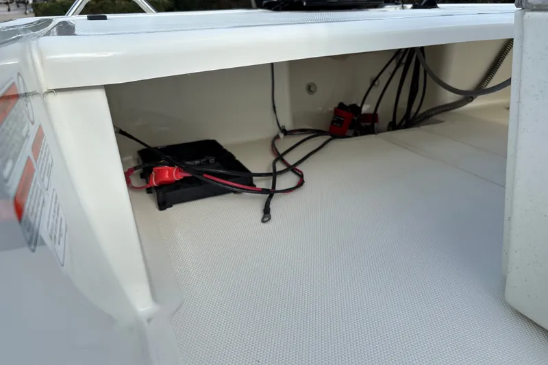 Slide: The Image of 2026 Mako Pro Skiff 15 CC boat interior wiring and battery compartment. - 16