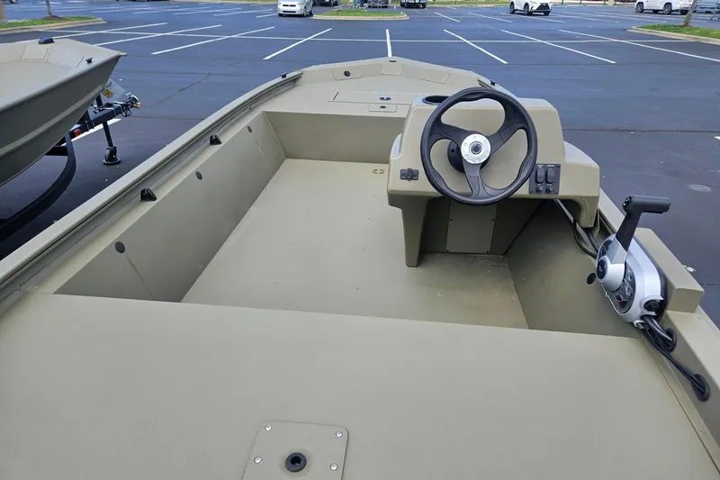 Slide: The Image of 2026 Tracker Grizzly 1648 SC boat interior with steering wheel and control panel. - 31