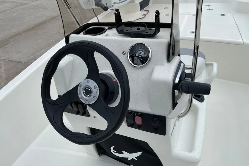 Slide: The Image of Steering console of 2026 Mako Pro Skiff 15 CC boat, featuring modern controls and design. - 11
