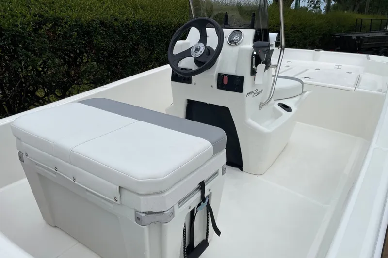 Slide: The Image of 2026 Mako Pro Skiff 15 CC boat interior with steering console and seating. - 13