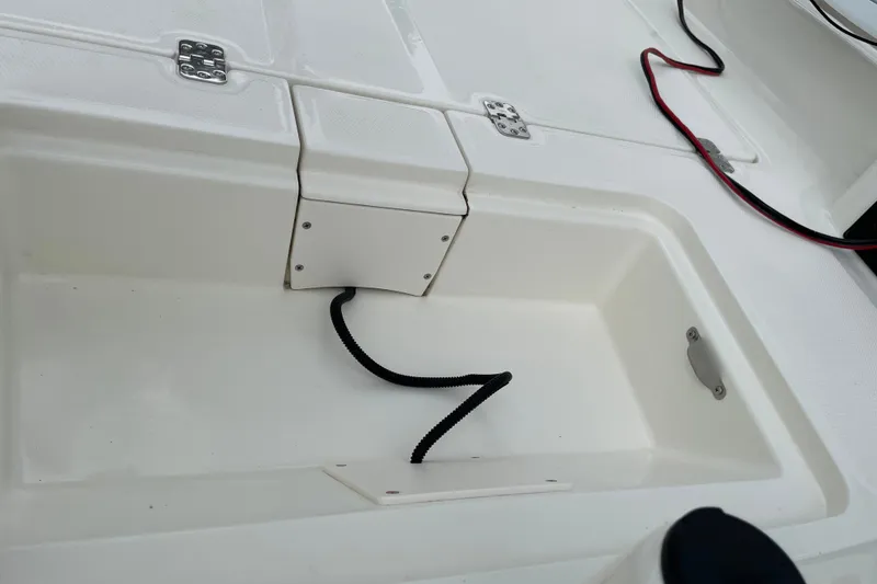 Slide: The Image of 2026 Mako Pro Skiff 15 CC boat interior with storage compartment and wiring. - 15