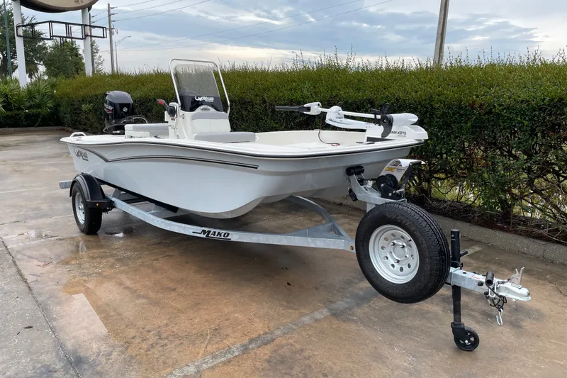 Slide: The Image of 2026 Mako Pro Skiff 15 CC boat on trailer, parked outdoors. - 4