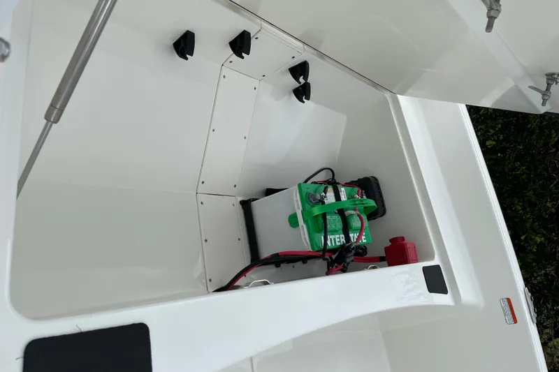 Slide: The Image of 2026 Mako Pro Skiff 15 CC boat storage compartment with battery and wiring. - 16