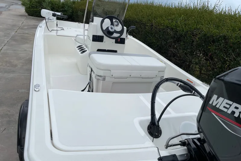 Slide: The Image of 2026 Mako Pro Skiff 15 CC boat with steering console and outboard motor. - 7