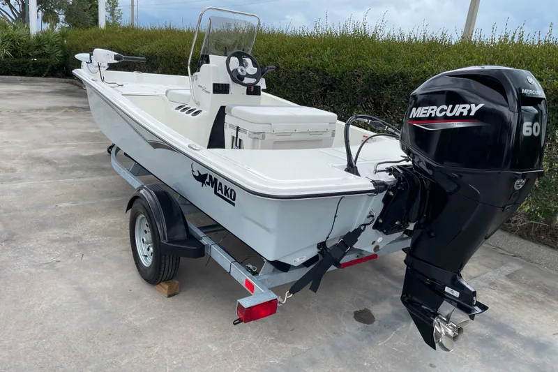 Slide: The Image of 2026 Mako Pro Skiff 15 CC boat with Mercury 60 engine on trailer. - 2