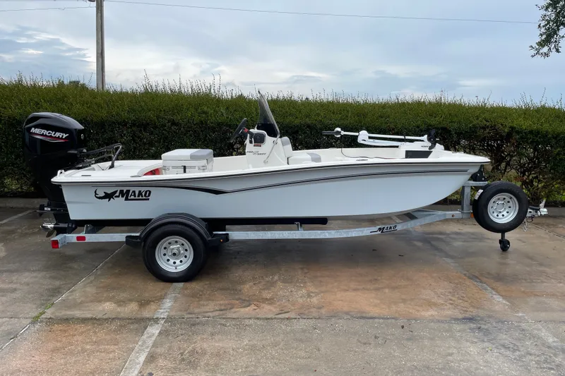 Slide: The Image of 2026 Mako Pro Skiff 15 CC boat on trailer, parked outdoors. - 3