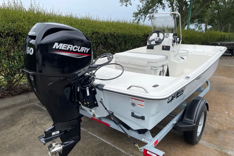 Slide: The Image of 2026 Mako Pro Skiff 15 CC boat with Mercury 50 engine on trailer. - 5
