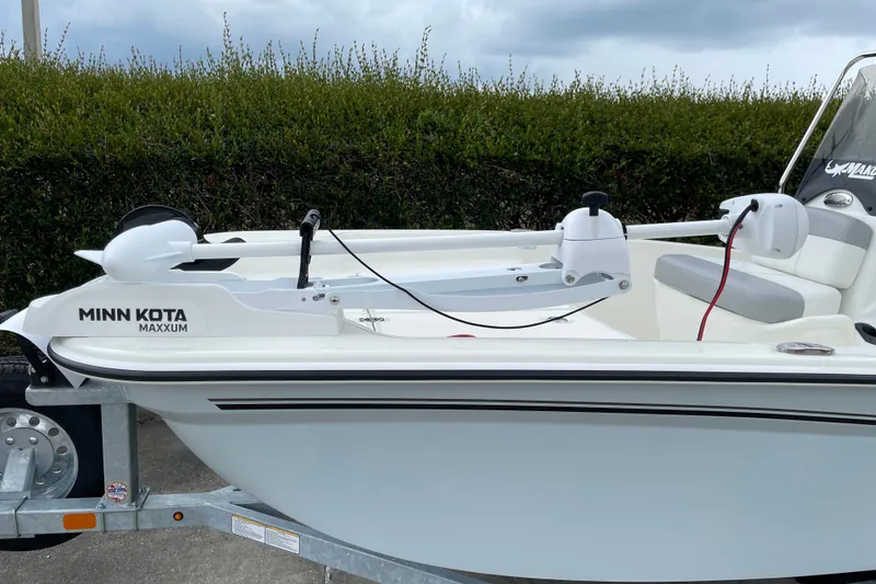 Slide: The Image of 2026 Mako Pro Skiff 15 CC with Minn Kota Maxxum trolling motor on trailer. - 8