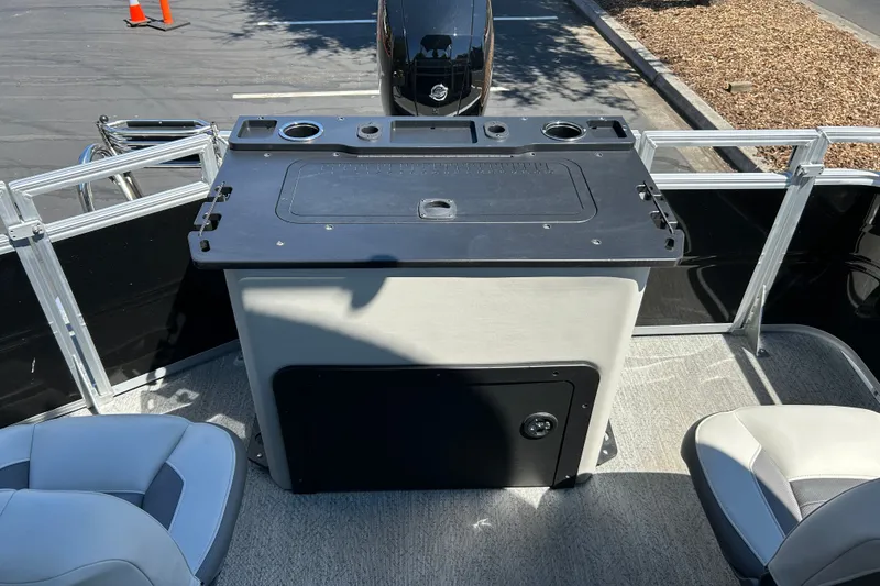 Slide: The Image of 2026 Sun Tracker Fishin' Barge 22 DLX interior with seating and control panel. - 19