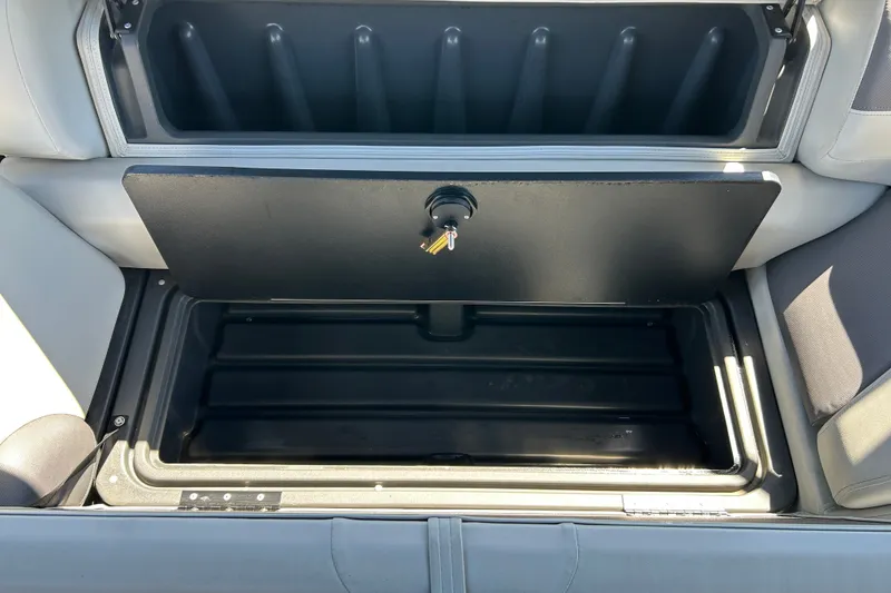 Slide: The Image of Open storage compartment on 2026 Sun Tracker Fishin' Barge 22 DLX boat. - 17