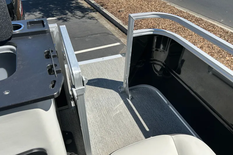Slide: The Image of 2026 Sun Tracker Fishin' Barge 22 DLX interior with seating and railing details. - 25