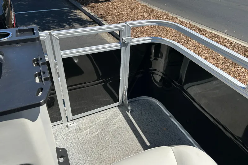 Slide: The Image of 2026 Sun Tracker Fishin' Barge 22 DLX interior with seating and railing details. - 23