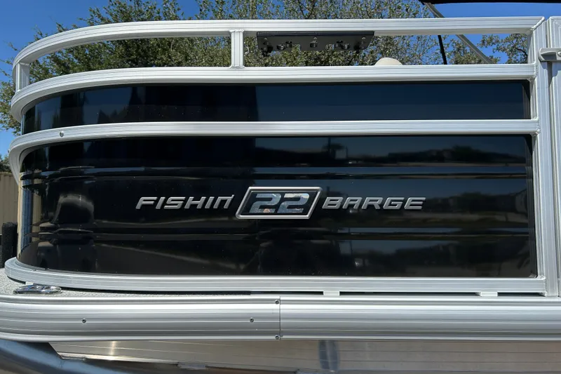 Slide: The Image of 2026 Sun Tracker Fishin' Barge 22 DLX pontoon boat with sleek black exterior. - 33