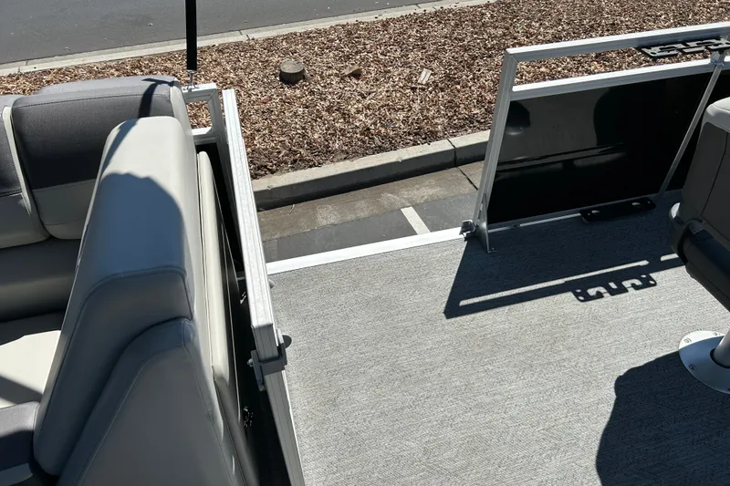 Slide: The Image of 2026 Sun Tracker Fishin' Barge 22 DLX interior with seating and open deck view. - 31
