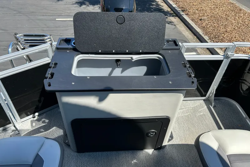 Slide: The Image of 2026 Sun Tracker Fishin' Barge 22 DLX livewell with open lid on deck. - 20